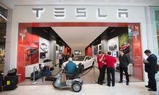 Tesla woos car-guy lawmakers with rides to counter dealers' cash